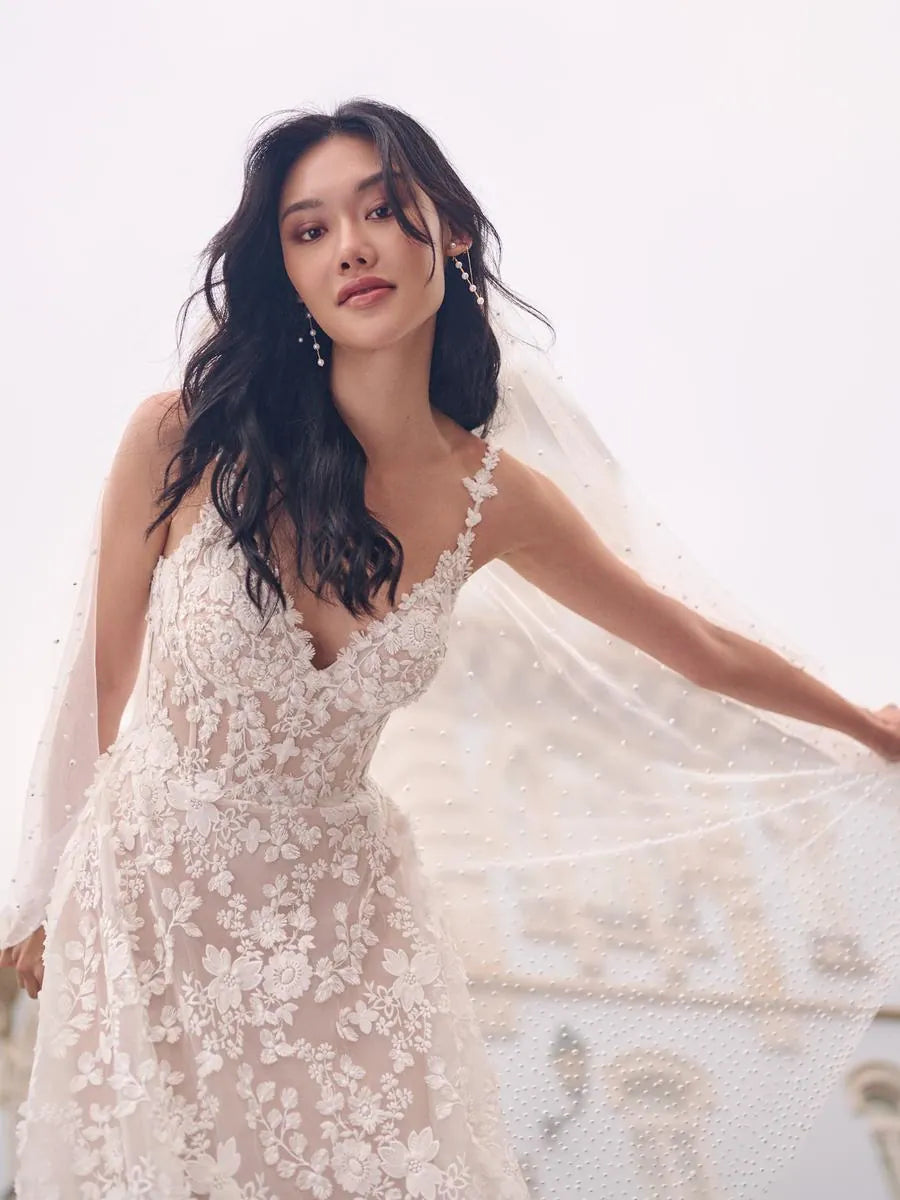 Woman in a white lace wedding dress with a blurred background