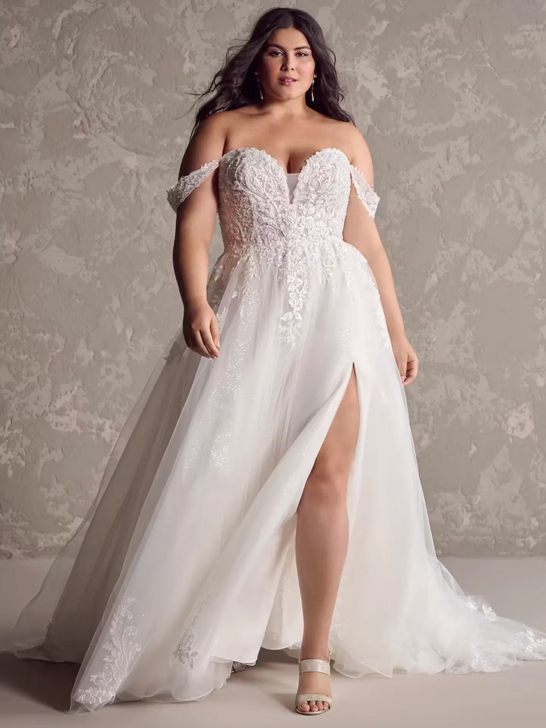 front of maggie sottero marguerite blush tulle a-line wedding dress with beaded lace appliques and a side slit in the skirt