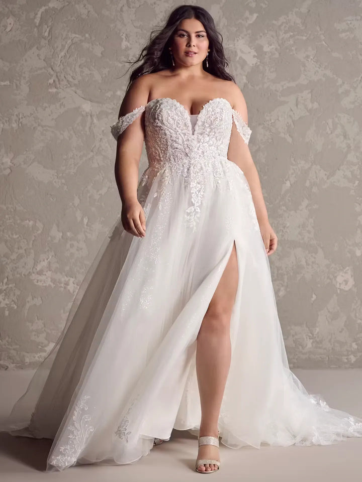 front of maggie sottero marguerite blush tulle a-line wedding dress with beaded lace appliques and a side slit in the skirt