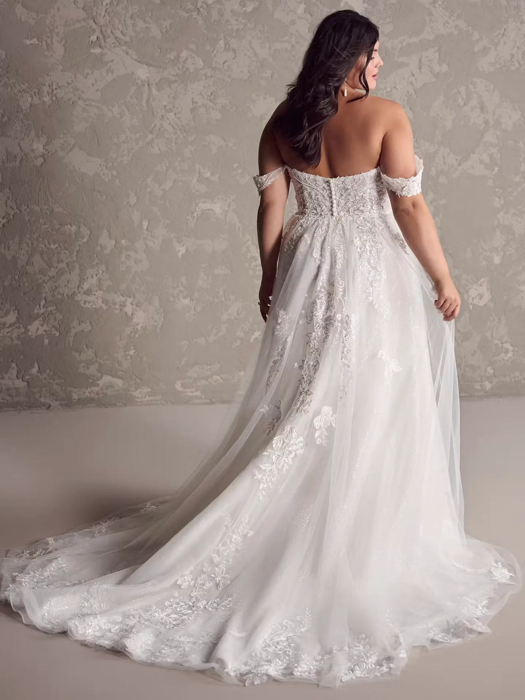 front of maggie sottero marguerite blush tulle a-line wedding dress with lace appliques down the skirt and chapel length train