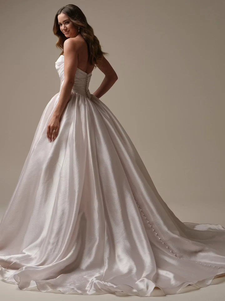 full back of maggie sottero paris organza ball gown featuring a basque waist and chapel length train with buttons down the back