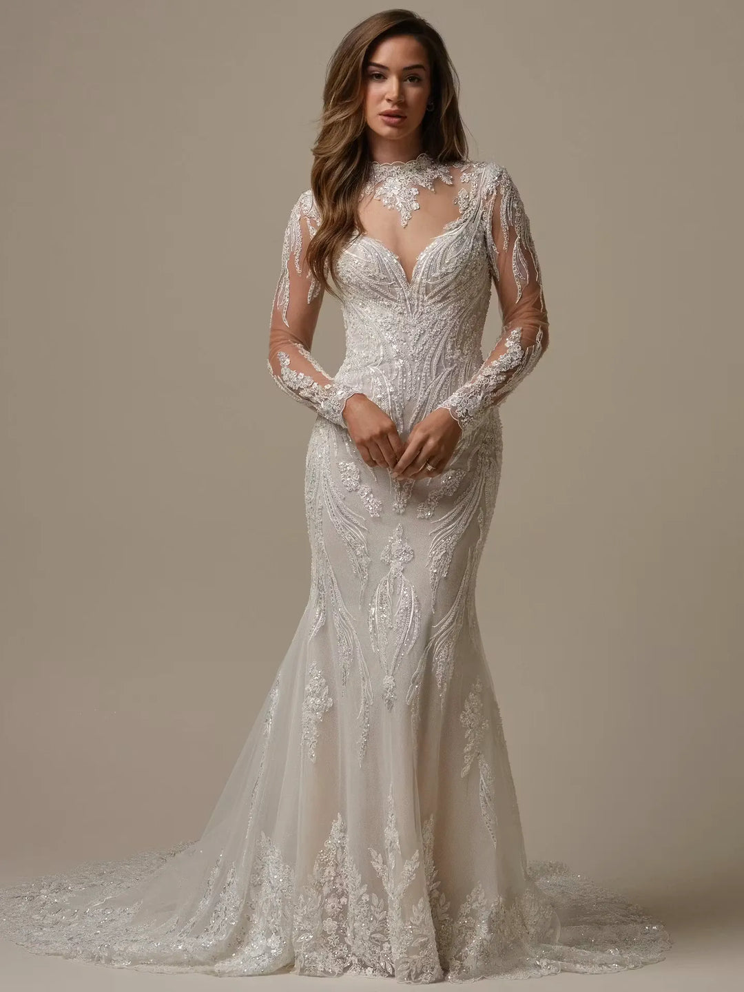 Woman wearing a lace wedding dress against a neutral background