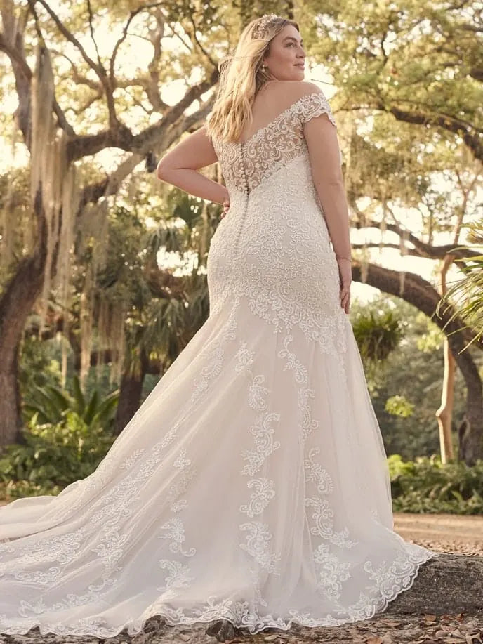 full back of maggie sottero keeva blush lace fit and flare wedding dress featuring a sheer back and chapel length train