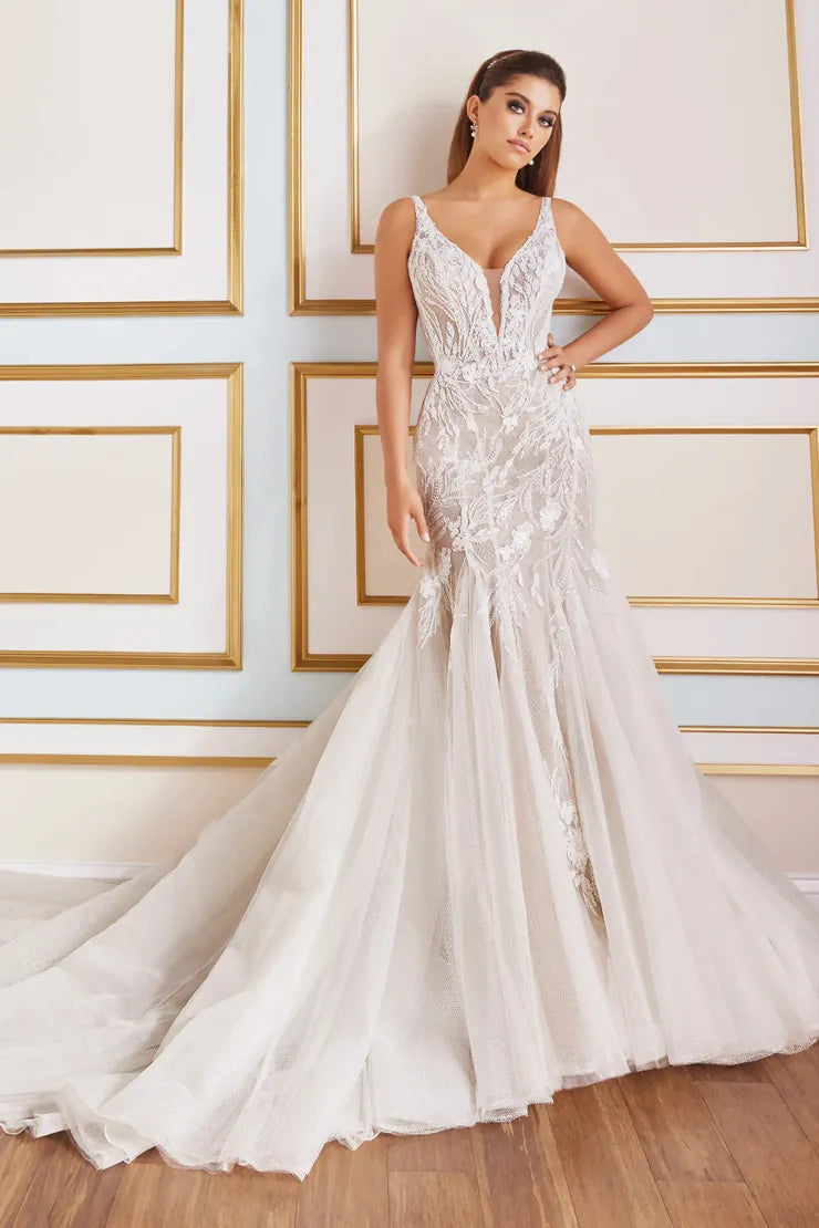 Woman wearing a white lace wedding dress in a room with gold trim.