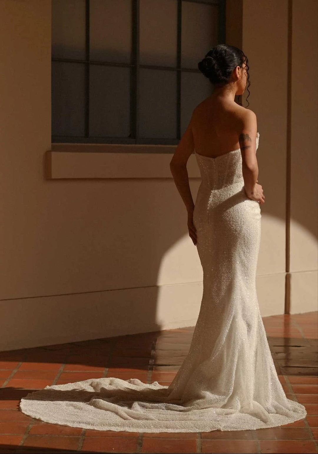 full back of martina liana 1678 ivory beaded fitted wedding dress, showing the strapless bodice and slim skirt with allover beading