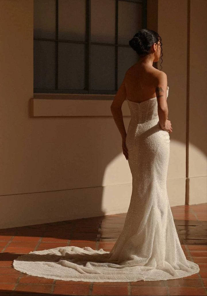 full back of martina liana 1678 ivory beaded fitted wedding dress, showing the strapless bodice and slim skirt with allover beading