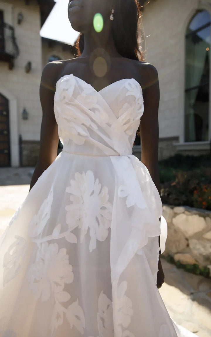 White floral dress worn by a model outdoors.
