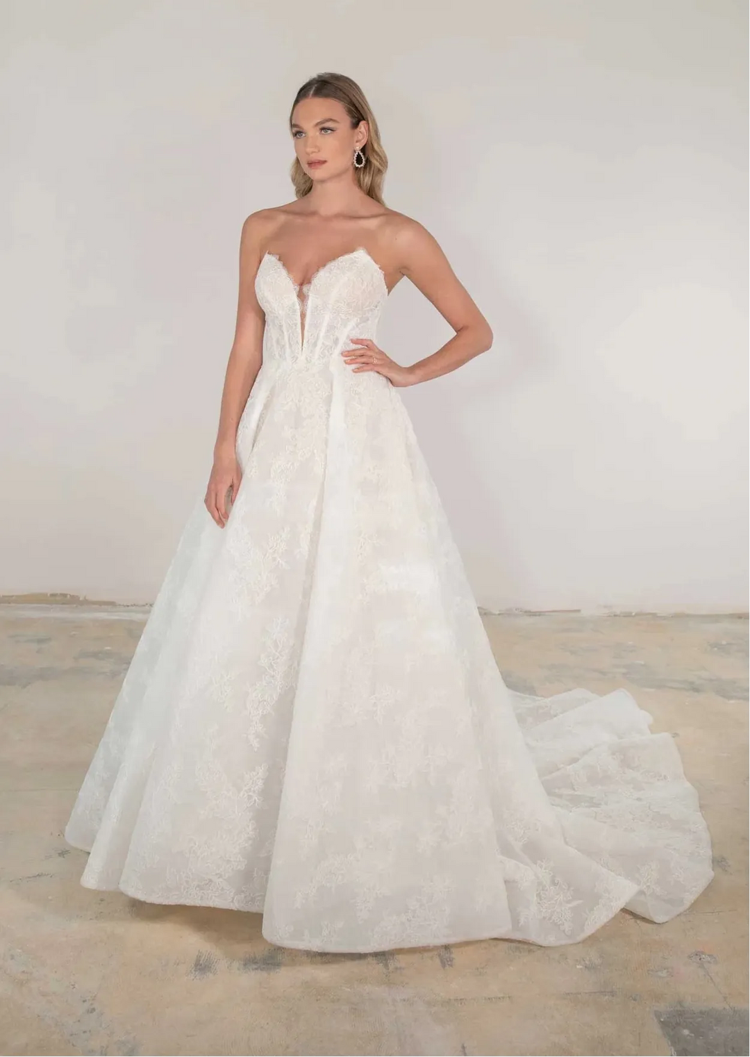 Woman wearing a strapless white wedding dress in a minimalistic setting