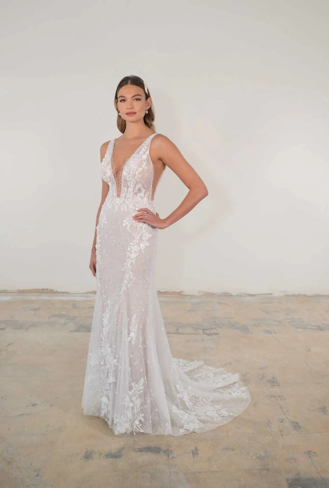 Woman wearing a white lace wedding dress in a minimalistic setting