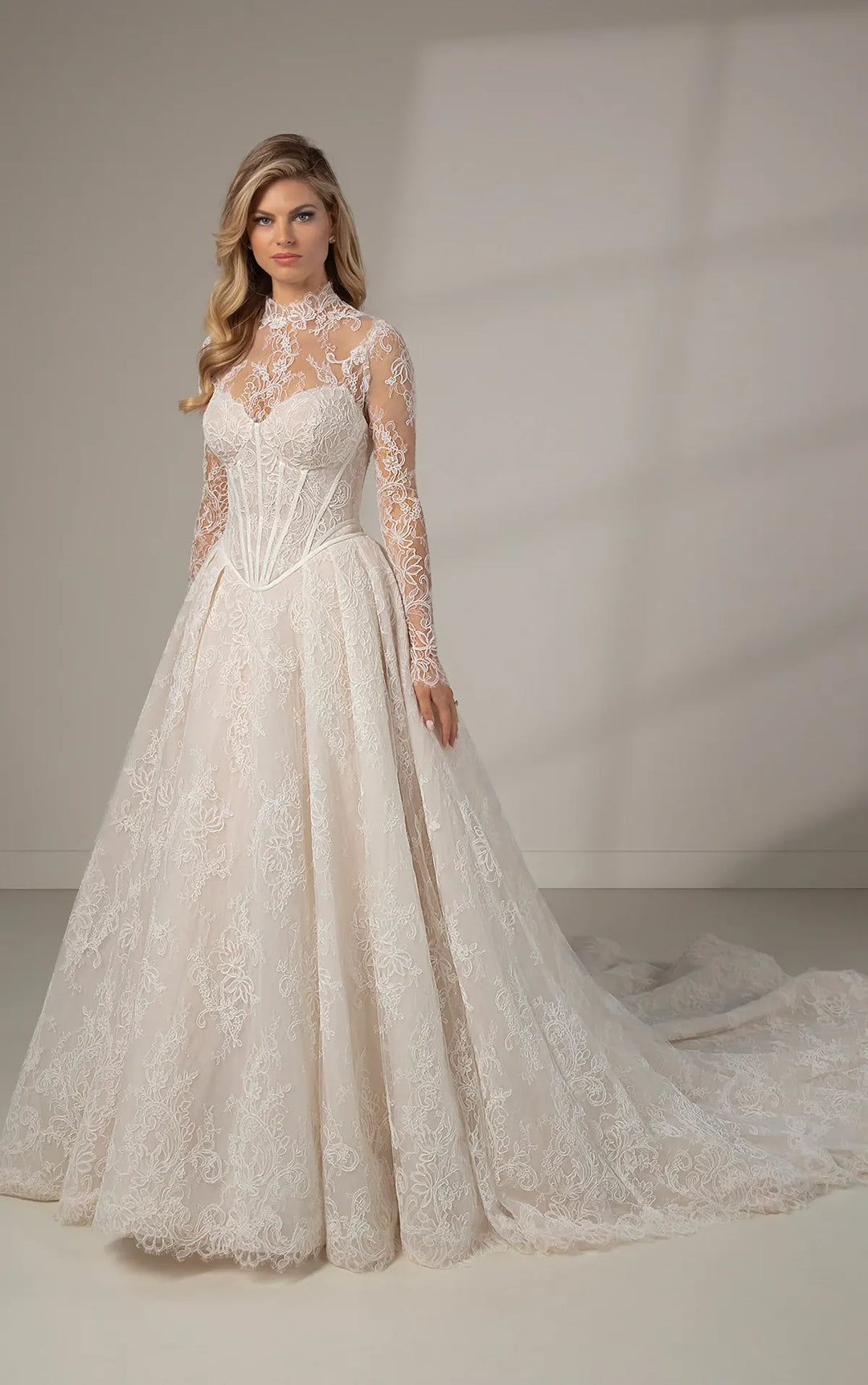 full front of martina liana le1384 ivory lace ball gown with a basque waist and matching long sleeve lace topper
