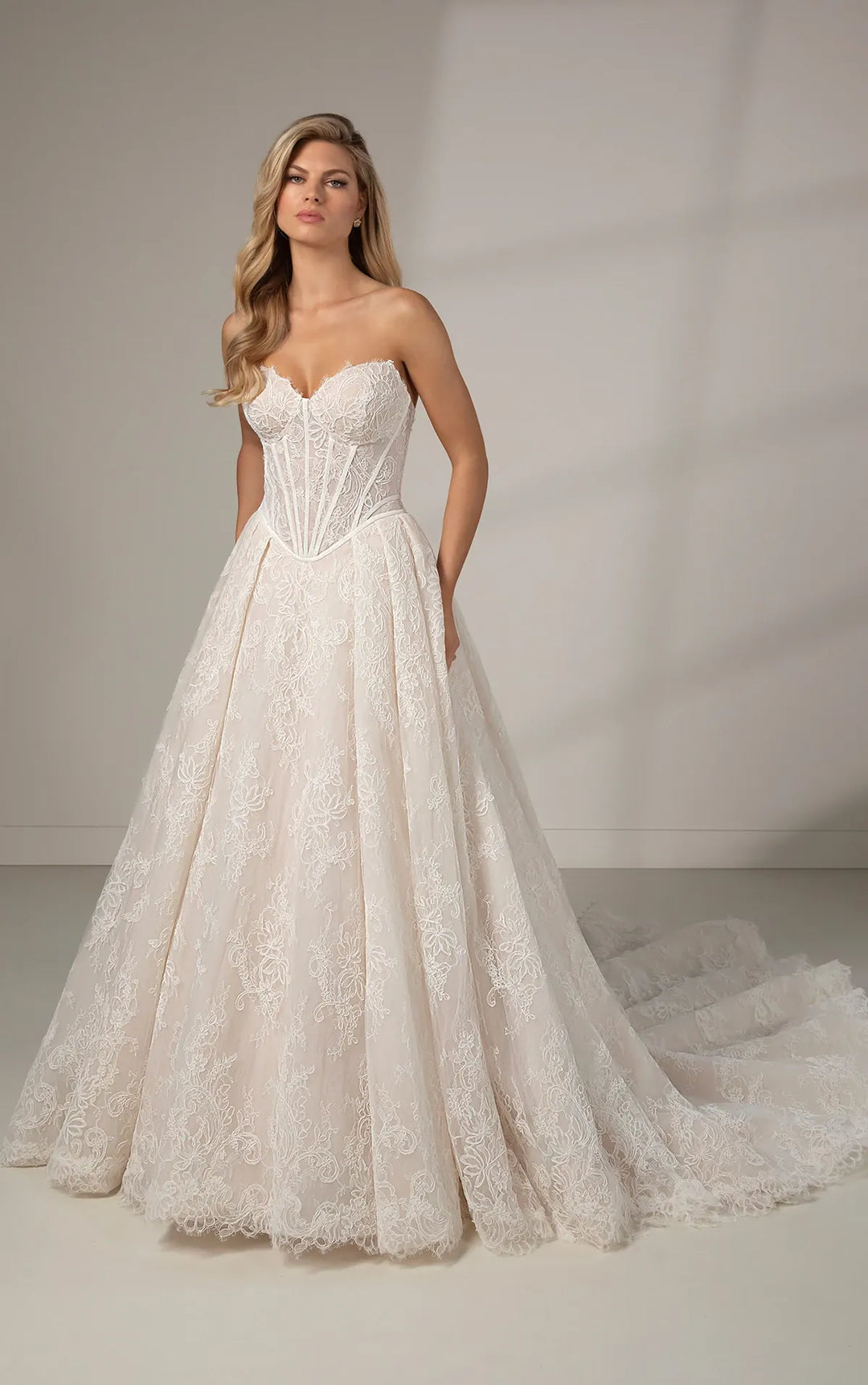 full front of martina liana le1384 ivory lace ball gown with a basque waist, shown without the matching long sleeve lace topper