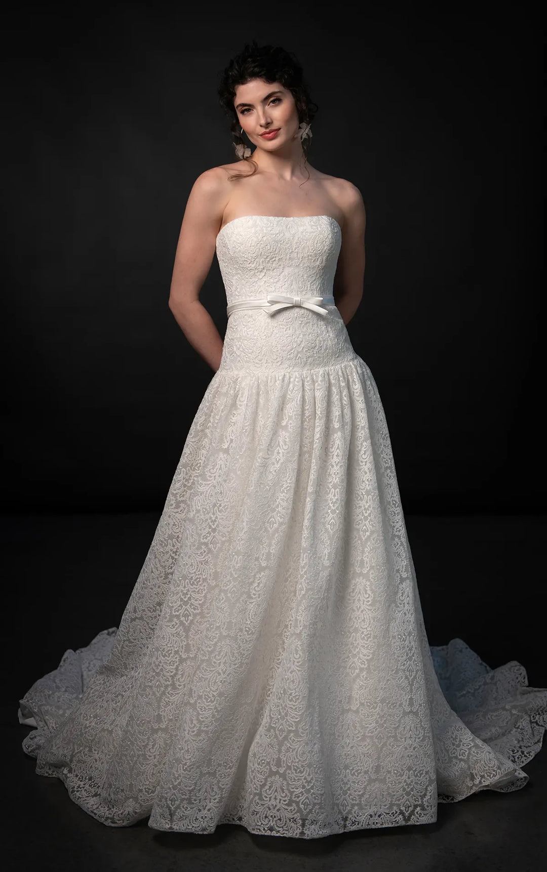 full front of martina liana ml1911 ivory lace drop waist wedding dress featuring a strapless bodice with a matching ivory ribbon belt