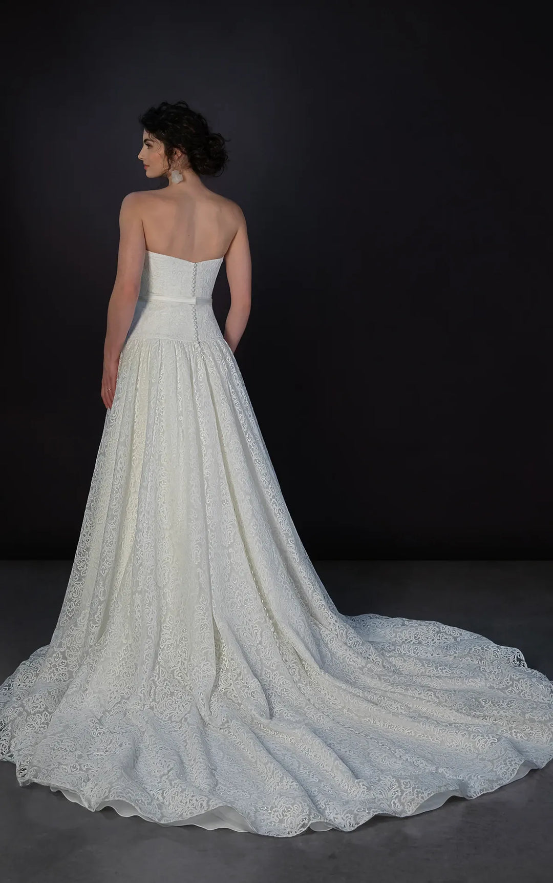 full back of martina liana ml1911 ivory lace drop waist wedding dress featuring a strapless bodice with a matching ivory ribbon belt and a chapel length train