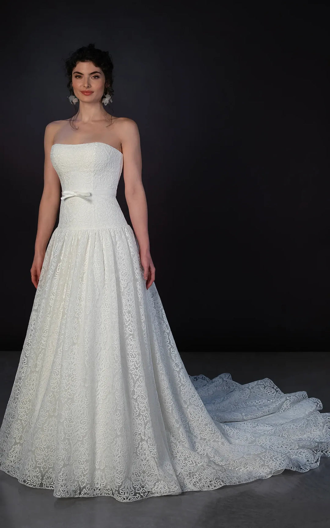 full front of martina liana ml1911 ivory lace drop waist wedding dress featuring a strapless bodice with a matching ivory ribbon belt