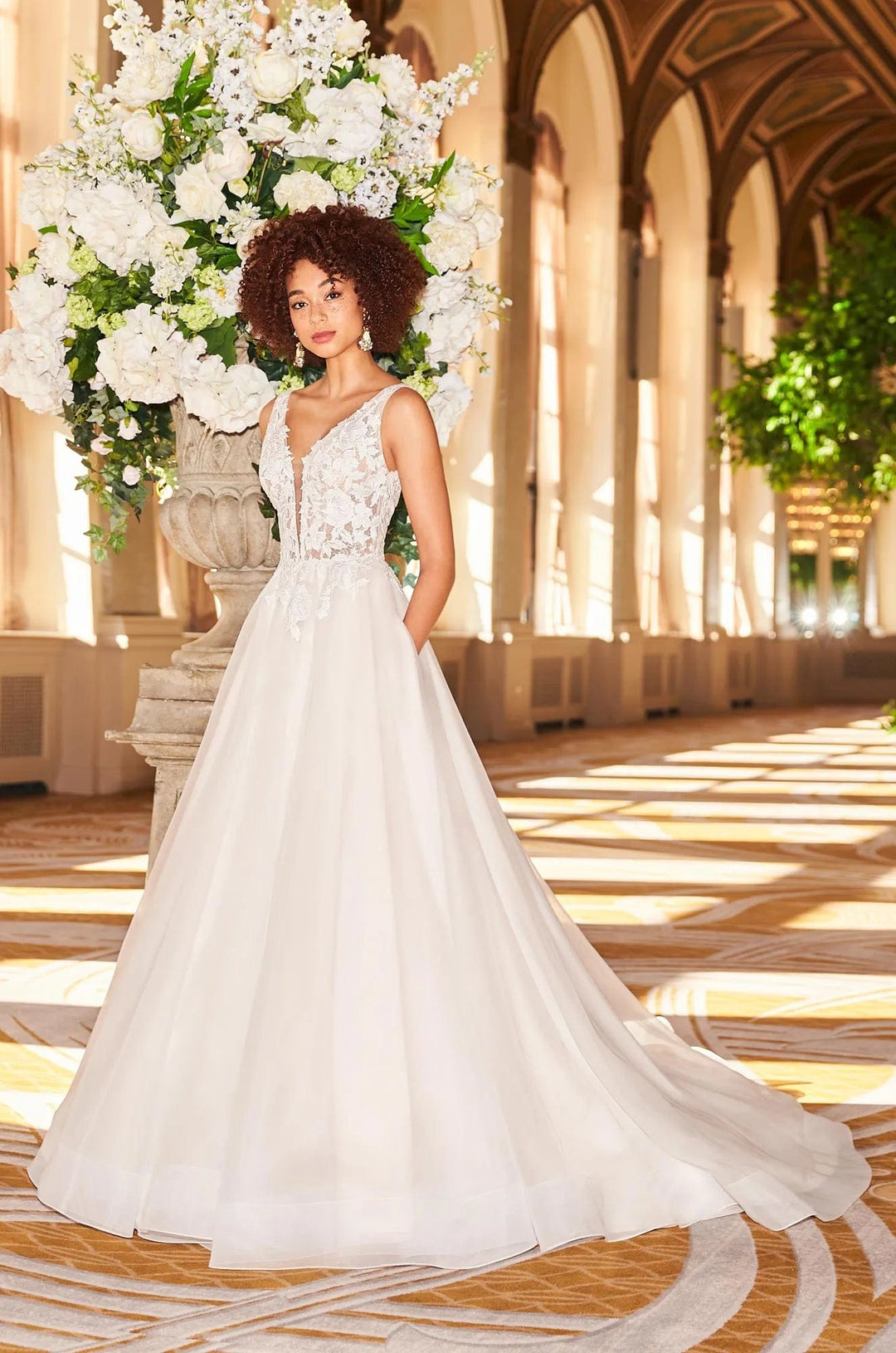 front of mikaella 2356 ivory tulle ball gown wedding dress with cascading lace appliques and a deep v neckline