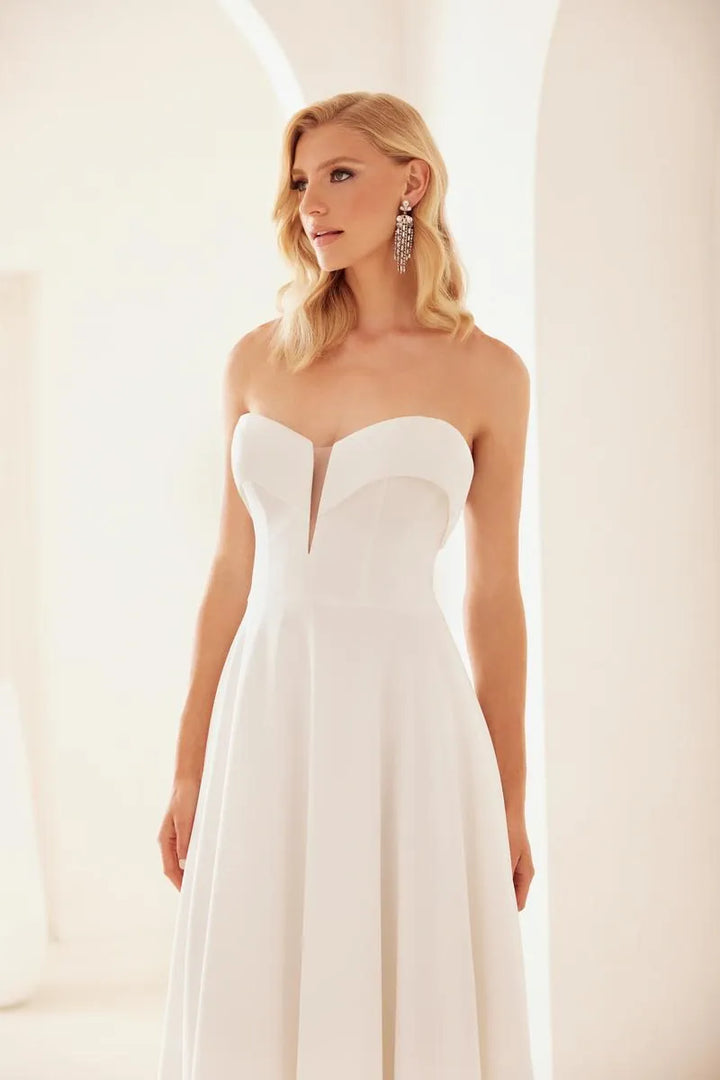close up of mikaella m2433 ivory crepe a-line wedding dress with deep V neckline with foldover accent on the neckline, without the off the shoulder straps