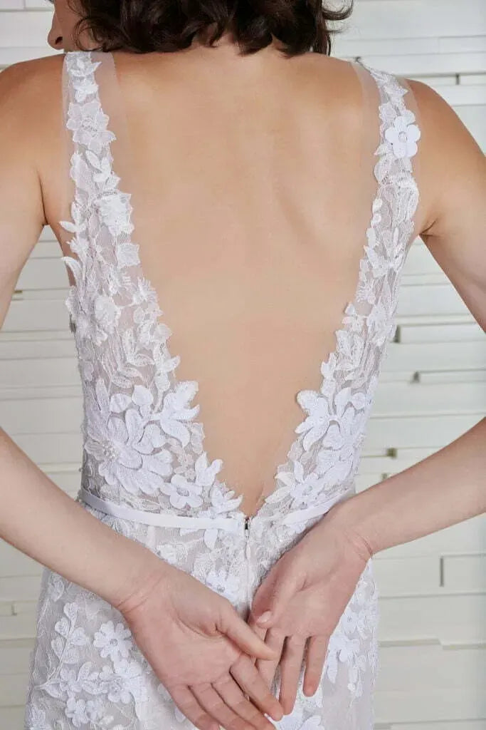 close up of the back of mira zwillinger jona ivory lace fitted wedding dress with a deep v neckline