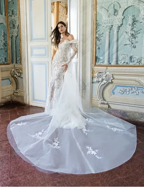 front fo monique lhuillier ferrara ivory lace fit and flare wedding dress with a off the shoulder long sleeve neckline and long train