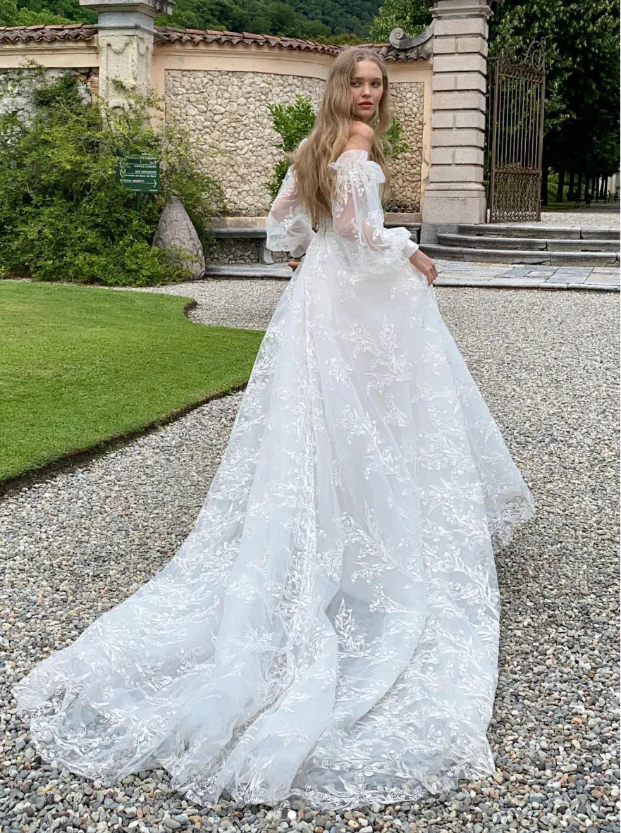 monique lhuillier long sleeve lace wedding dress BL26103: delicate, airy lace sweeps over a high neck long sleeve trumpet gown. Finished with a keyhole back, romance is brought to life. # moniquelhuillier #mlbride #mlbliss