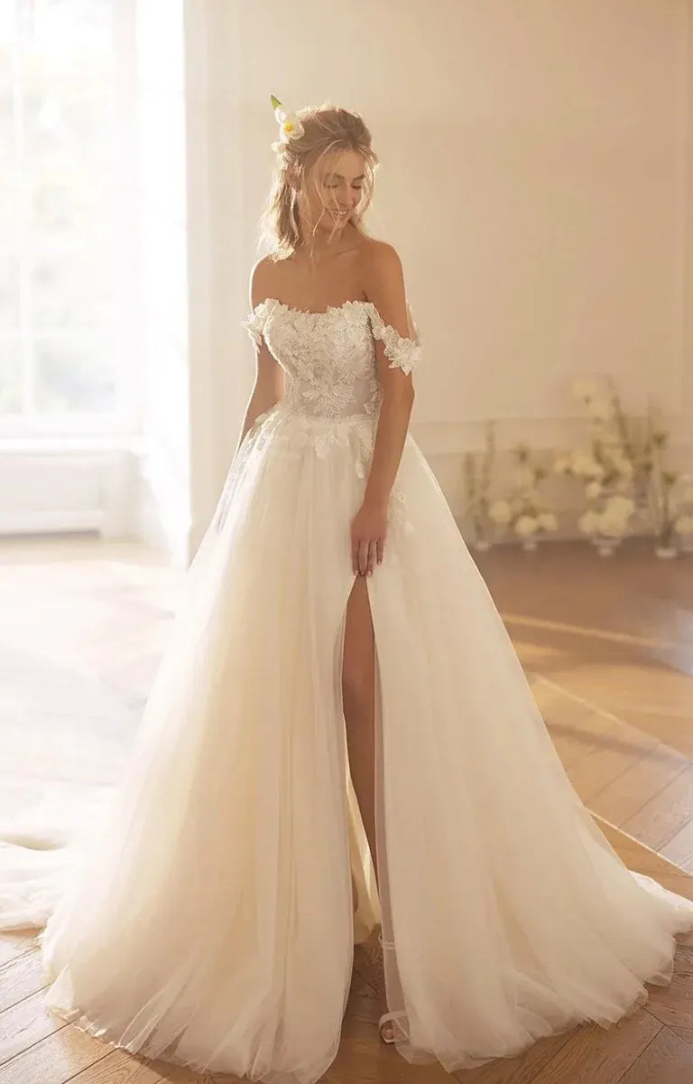 front of monreal ksenia ivory tulle ball gown showing the lace bodice and layered skirt with a slit in the side