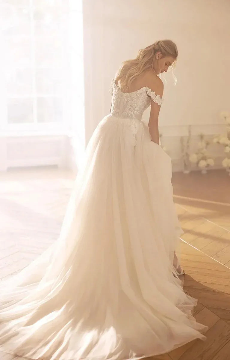 back of monreal ksenia ivory tulle ball gown showing the lace bodice and chapel length train