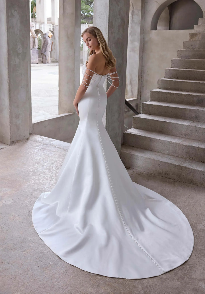 back of morilee atete ivory satin fit and flare wedding dress with buttons down the back and a chapel length train