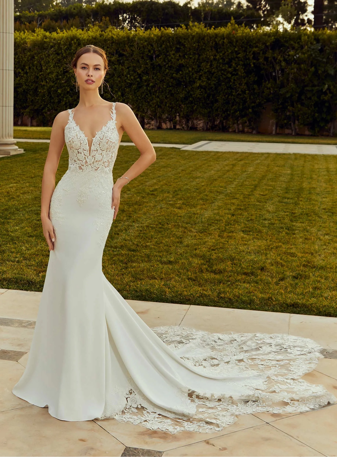 full front of morilee raquel ivory crepe fitted wedding dress featuring a v neckline, lace appliques throughout, and a shaped lace train