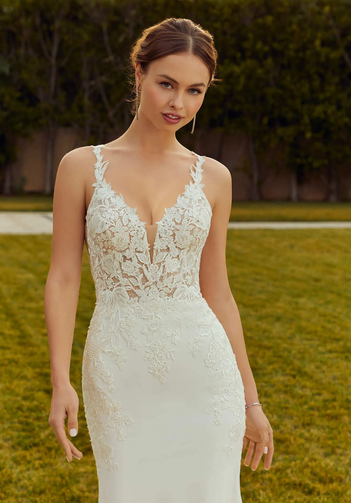 close up of morilee raquel ivory crepe fitted wedding dress showing the v neck lace bodice