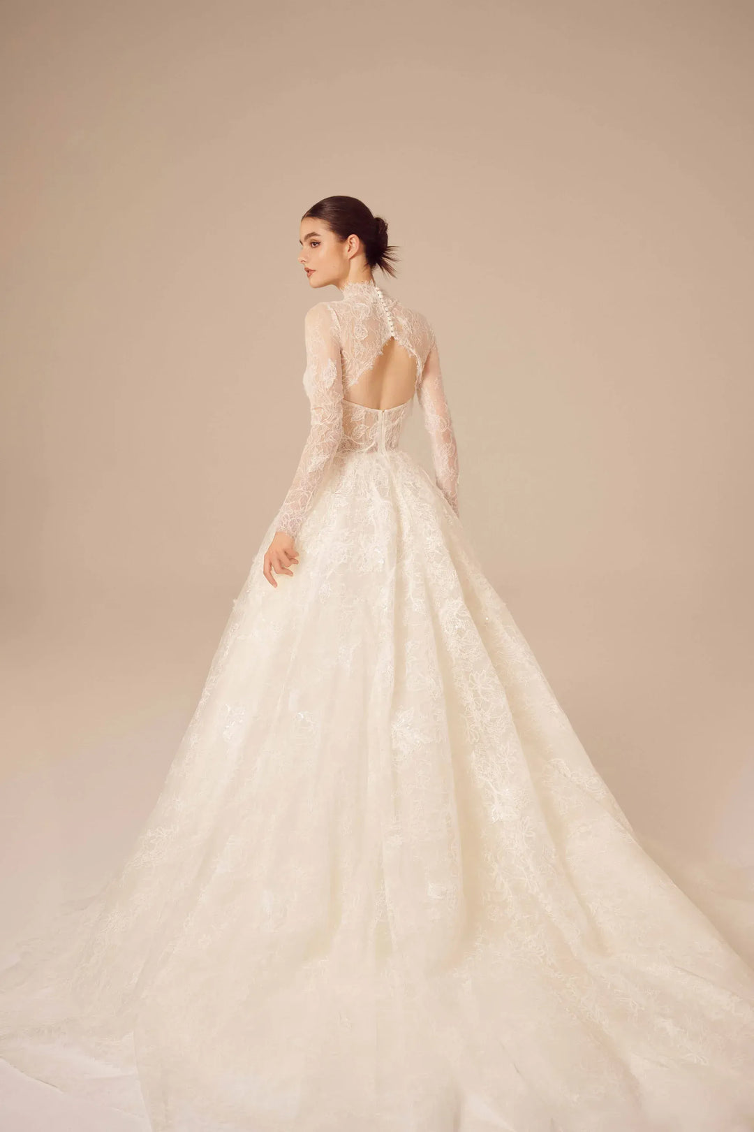 full back of nicole and felicia nf025 ivory lace ball gown wedding dress featuring an open back and long sleeve jacket, which is sold separately