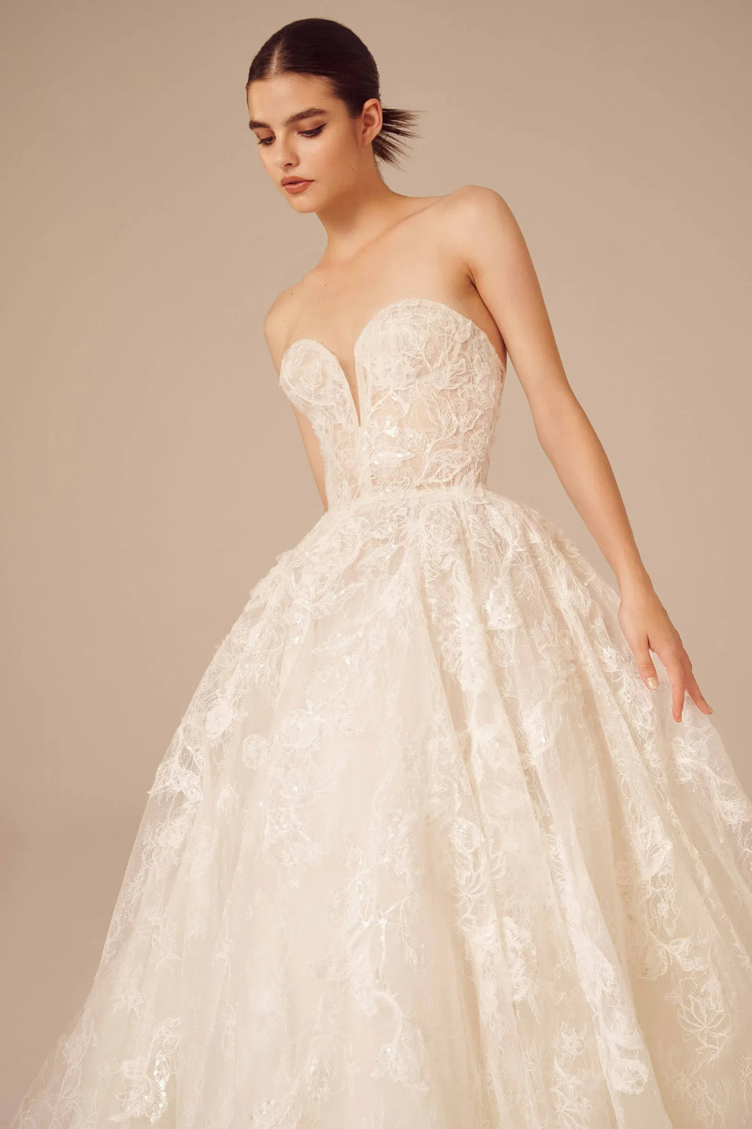 front of nicole and felicia nf025 ivory lace ball gown wedding dress featuring a strapless sweetheart neckline