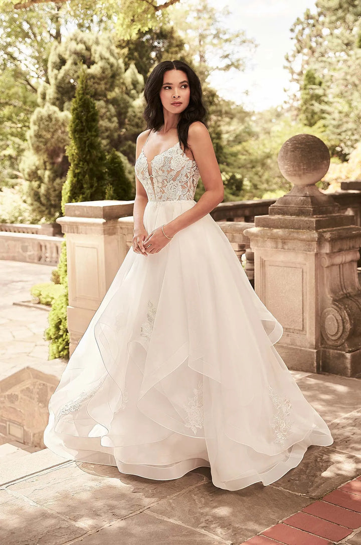 full front of paloma blanca 4930 ivory organza ball gown wedding dress with a tiered skirt and lace details