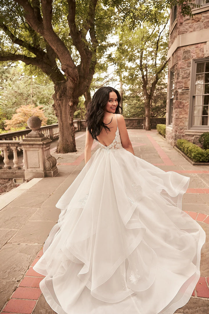 full back of paloma blanca 4930 ivory organza ball gown wedding dress with a tiered skirt and lace details