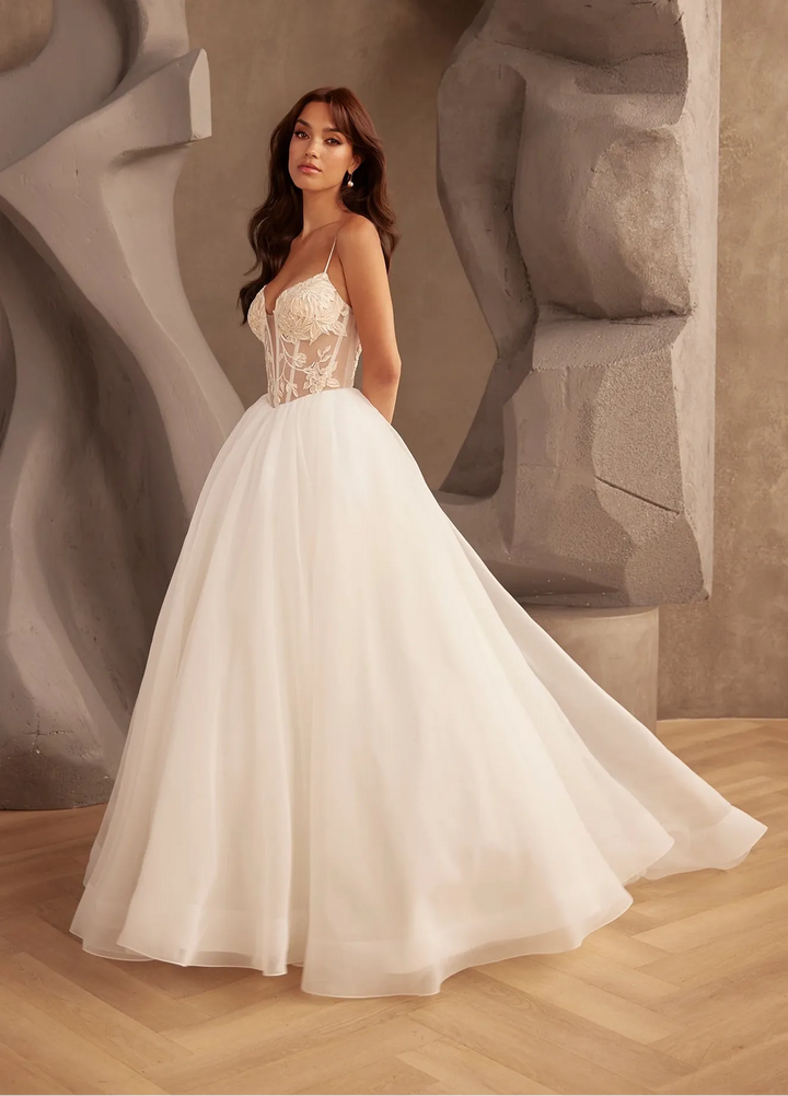 full front of paloma blanca p5126 ivory tulle ball gown wedding dress featuring a basque waist, lace bodice, and thin straps