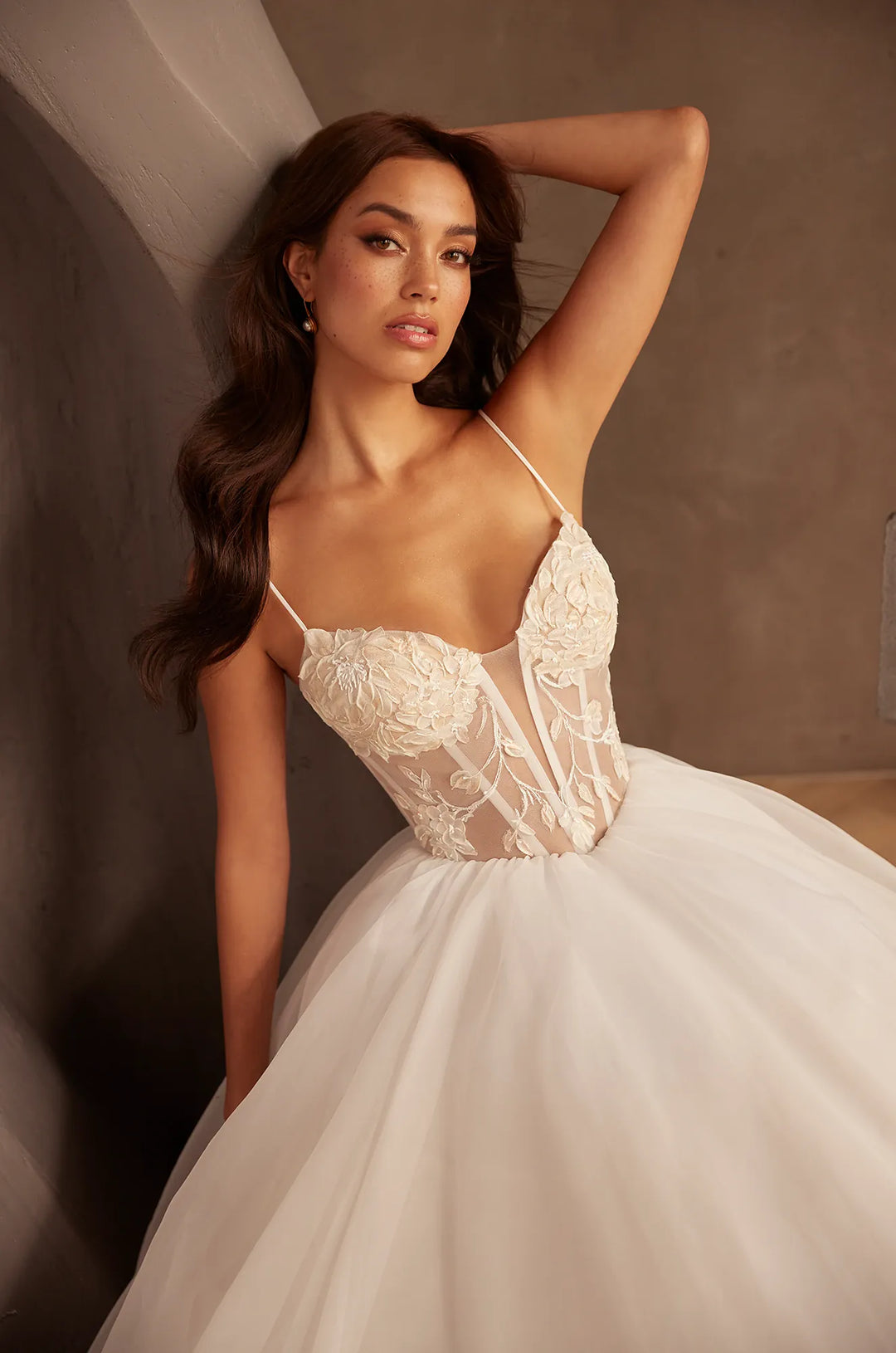close up of paloma blanca p5126 ivory tulle ball gown wedding dress showing the lace bodice and basque waist