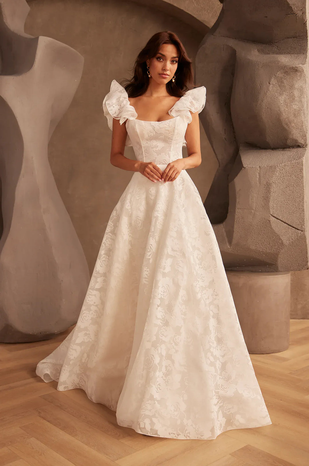 front of paloma blanca p5137 ivory burnout organza a-line wedding dress with a scoop neckline, shown with the matching ruffle straps