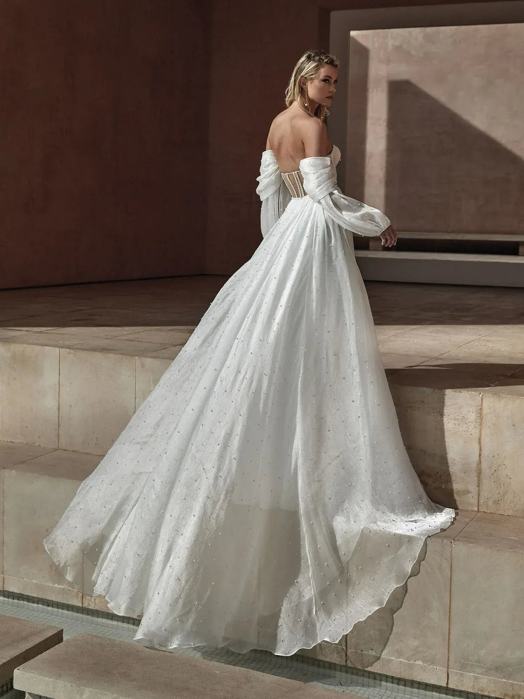 full back of pronovias balia ivory tulle ball gown featuring detachable long billowing sleeves