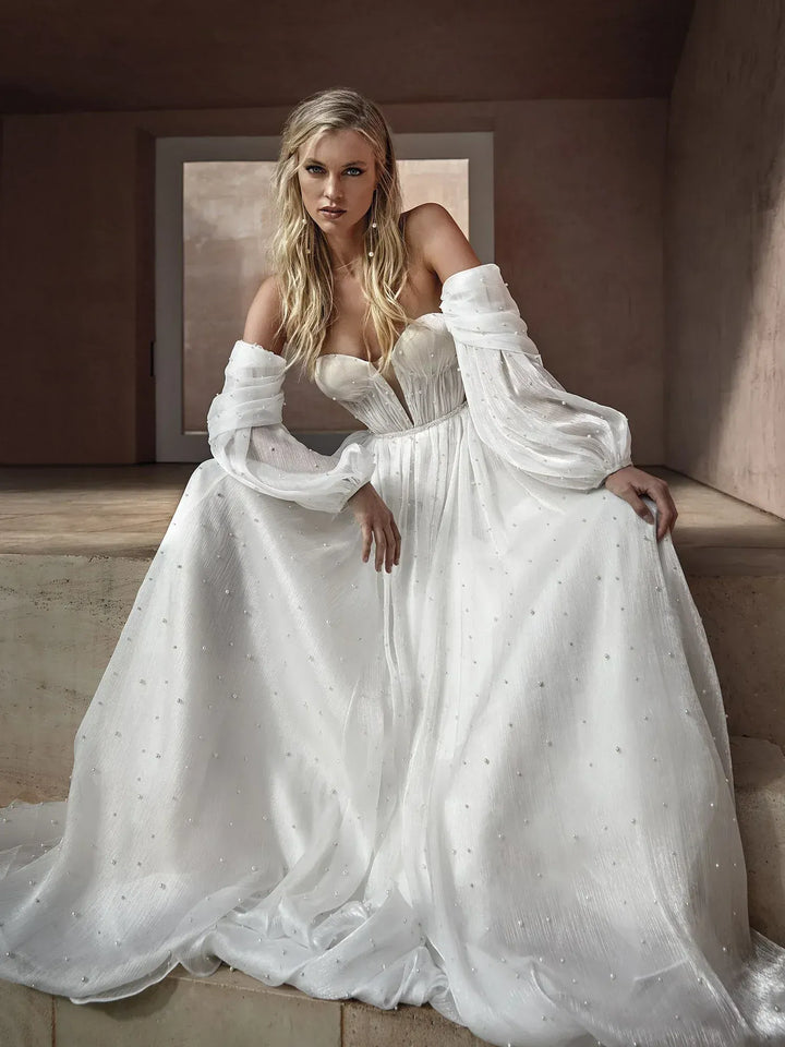 full front of pronovias balia ivory tulle ball gown featuring detachable long billowing sleeves