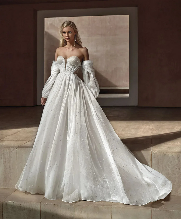 full front of pronovias balia ivory tulle ball gown featuring detachable long billowing sleeves