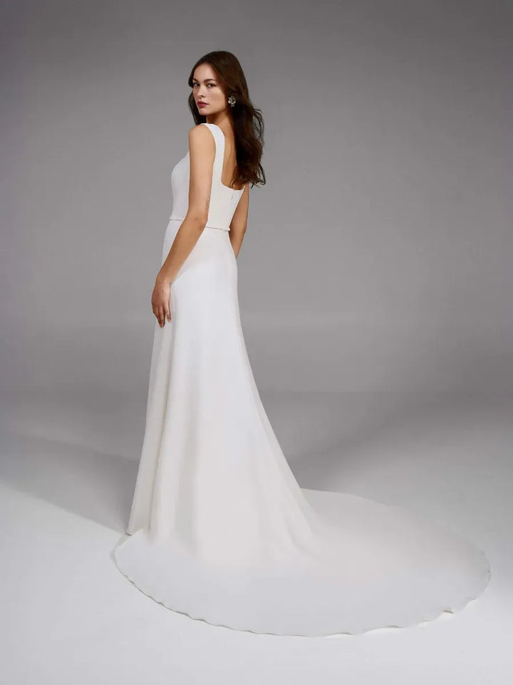 full back of pronovias holane ivory crepe fitted wedding dress featuring a square neckline with thick straps
