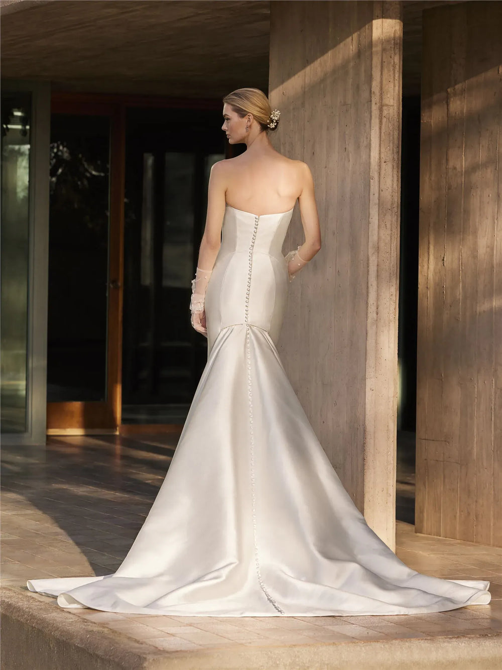 full back of pronovias magnolie ivory mikado fit n flare wedding dress with a scoop neckline and flared skirt