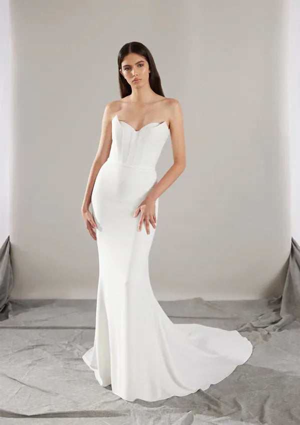 full front of pronovias sincere ivory crepe fitted wedding dress featuring a peekaboo neckline accent on the bodice