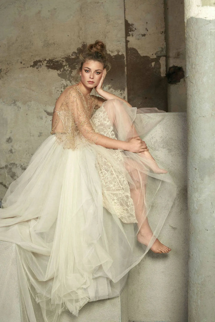 close up of rara avis holli tulle a-line bridal set with a deep neckline and matching gold topper