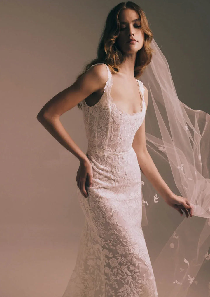 close up of renhue aster ivory lace fitted wedding dress with a scoop neckline