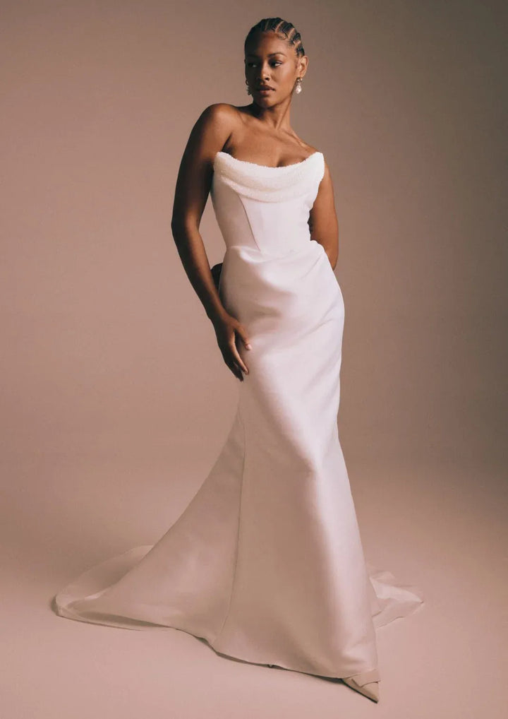 front of renhue celeste ivory mikado fit and flare wedding dress, showing the full front with the beaded drape across the neckline and fitted skirt