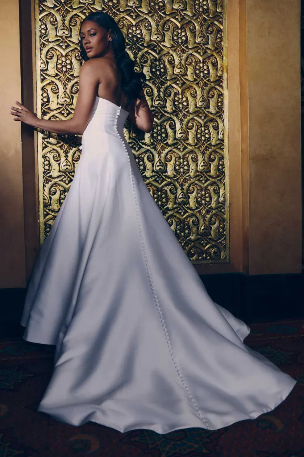 back of renhue ella ivory mikado a-line wedding dress with covered buttons down the skirt and onto the chapel length train