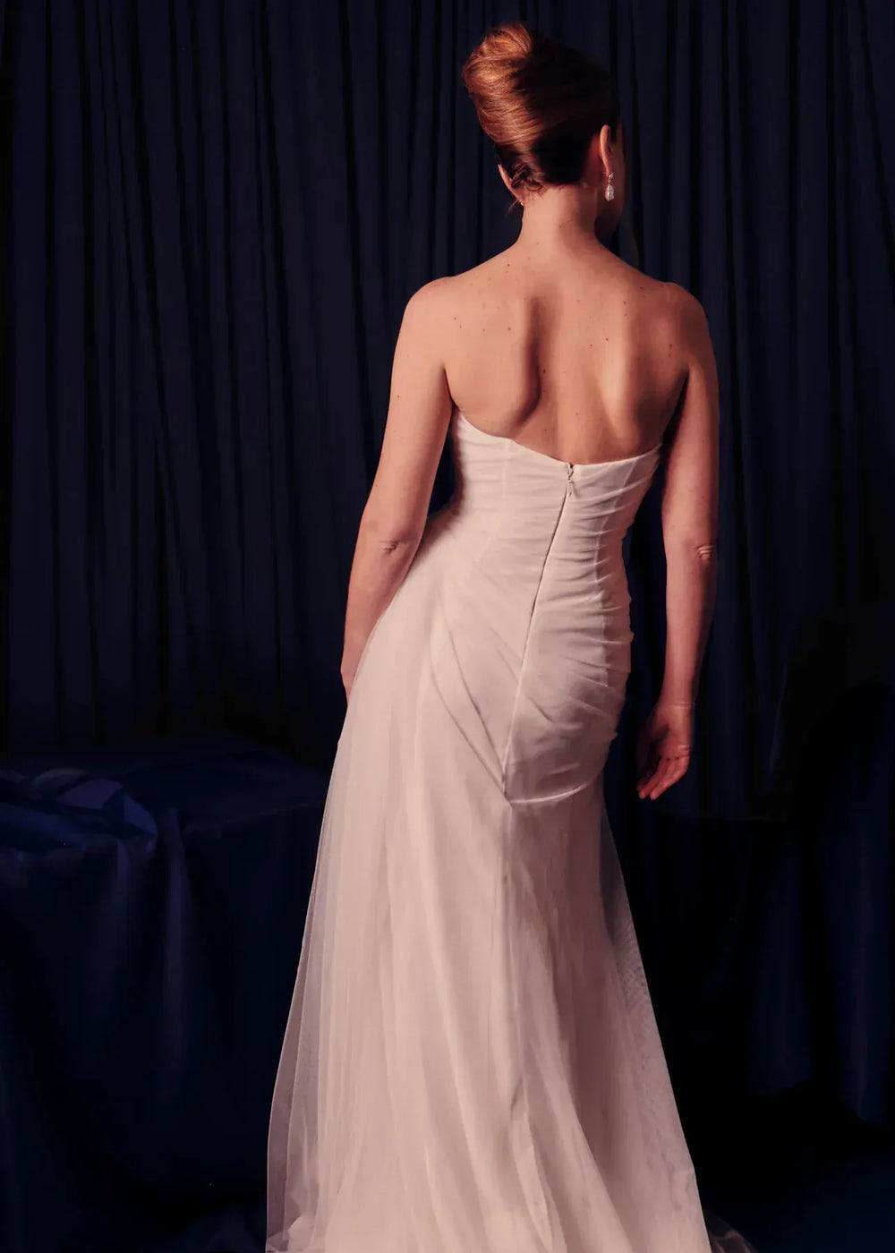 full back of renhue faye ivory tulle sheath wedding dress with a straight neckline and strapless bodice, with draping throughout