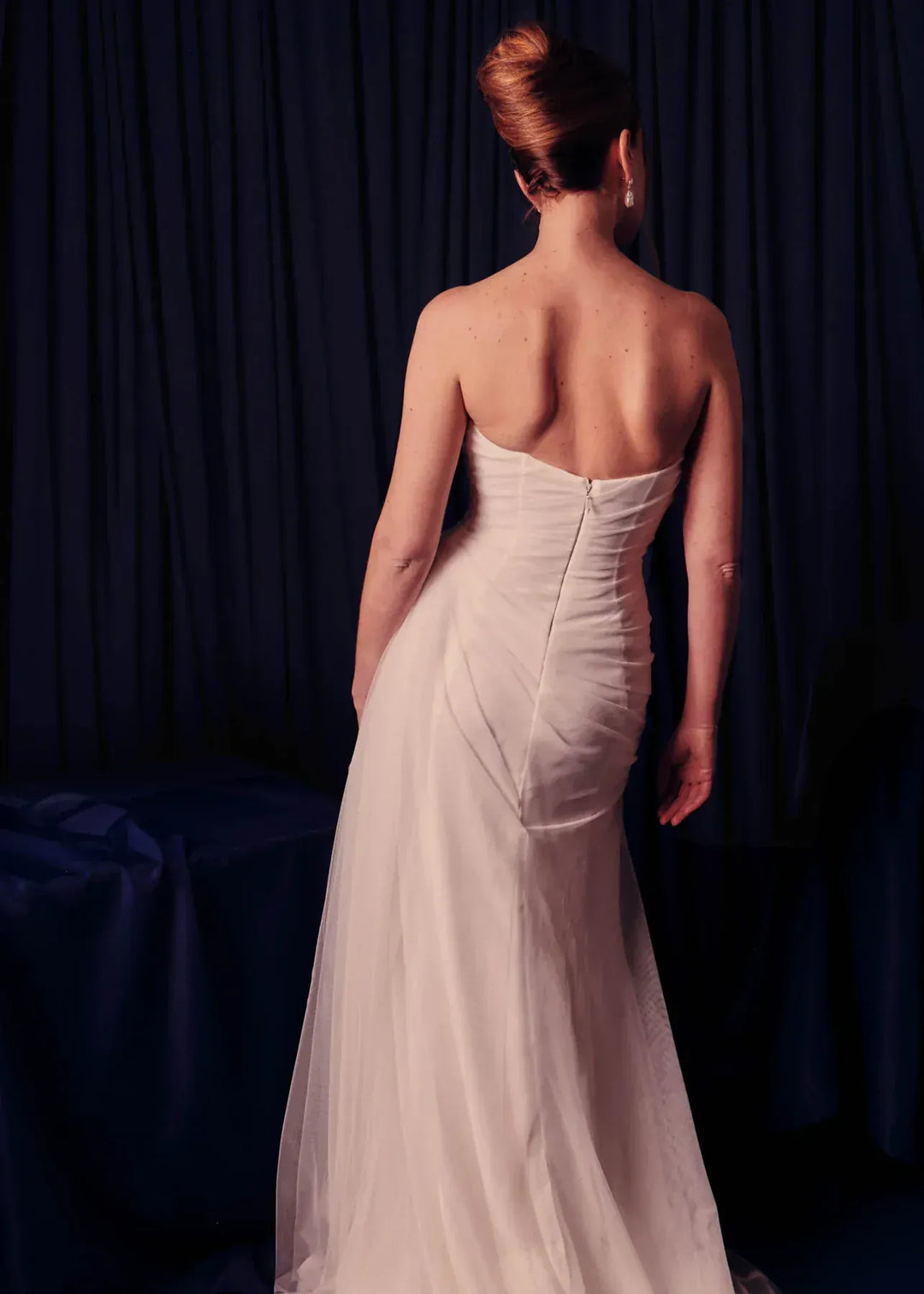 full back of renhue faye ivory tulle sheath wedding dress with a straight neckline and strapless bodice, with draping throughout