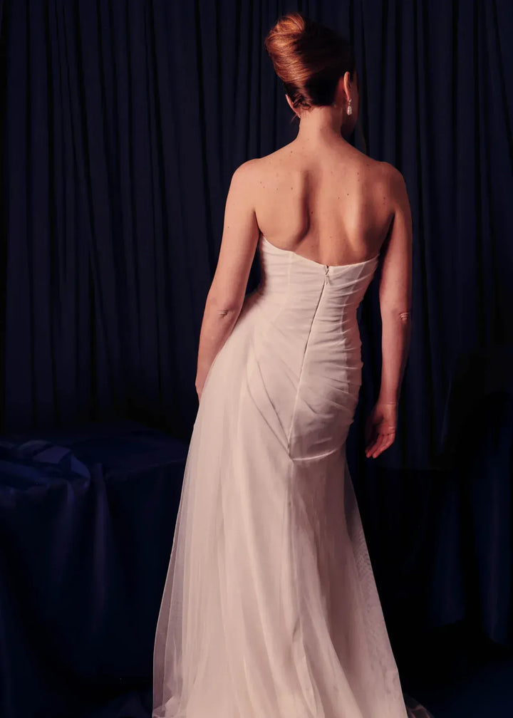 full back of renhue faye ivory tulle sheath wedding dress with a straight neckline and strapless bodice, with draping throughout