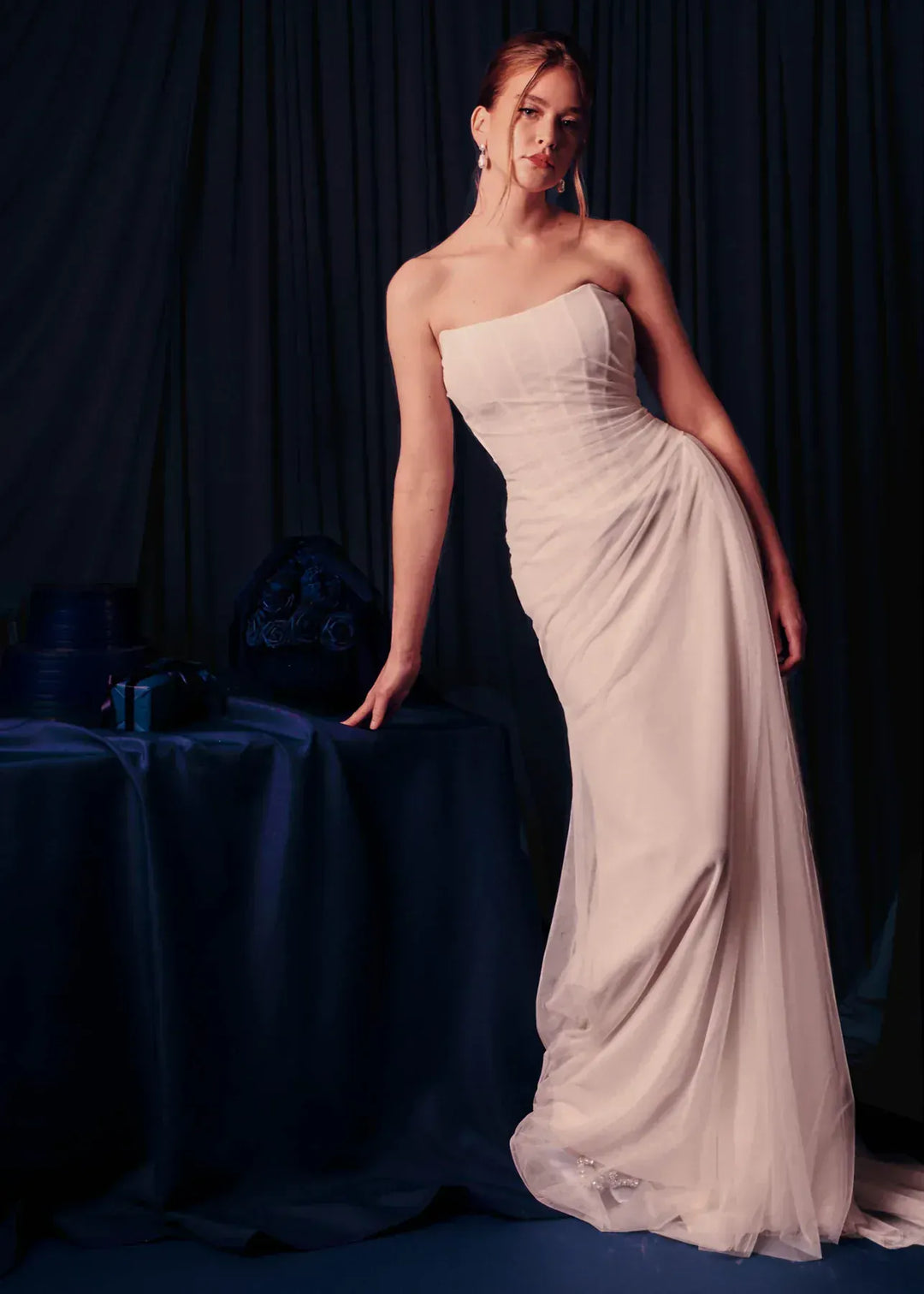 full front of renhue faye ivory tulle sheath wedding dress with a straight neckline and strapless bodice, with draping throughout
