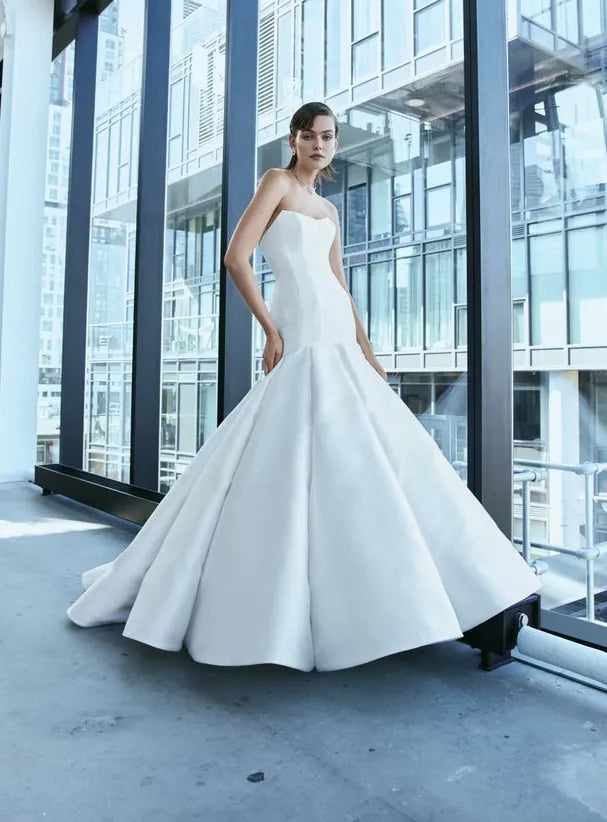 front of rivini clair ivory silk fit and flare wedding dress with strapless bodice and dramatic skirt